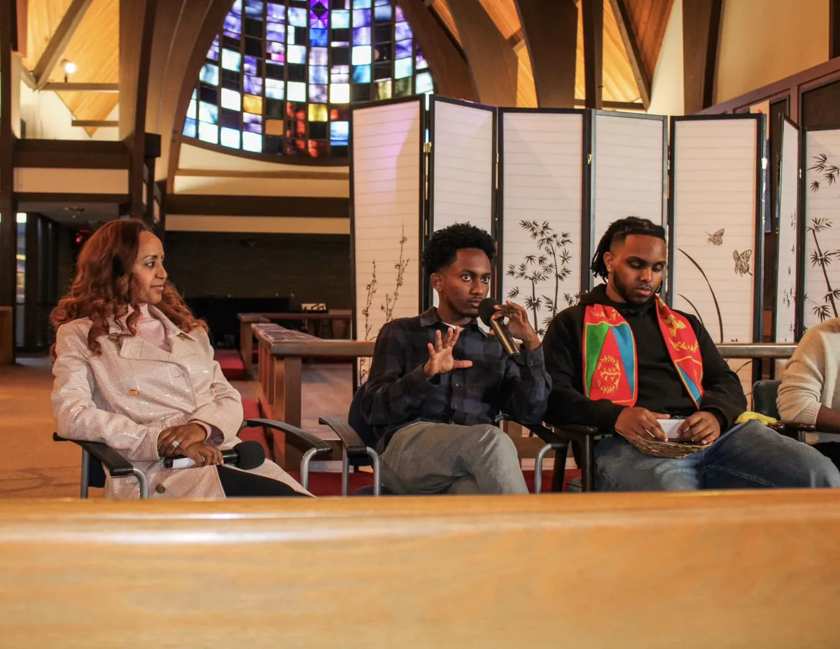 Speakers seated on a panel discussion in the sanctuary