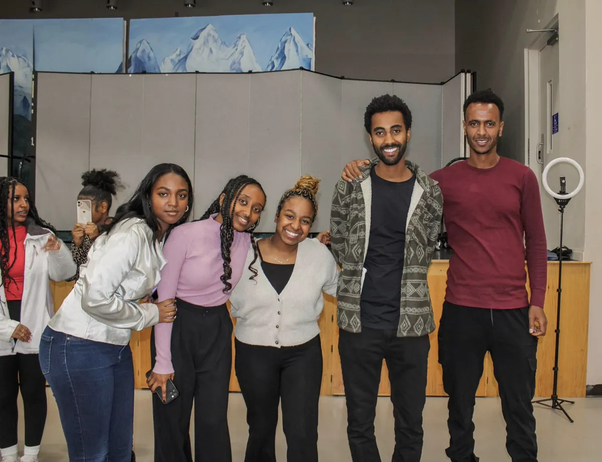 Young adults posing together at a youth event